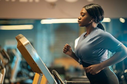 Beautiful woman at the gym exercising on a treadmill