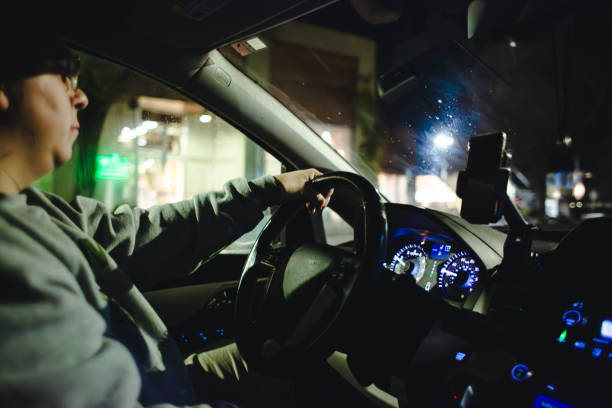 istock Adult Man Driving Car at Night 1865004820
