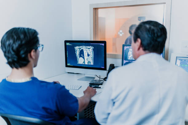 istock Doctors analyzing medical tomography x-ray at hospital 1865007508