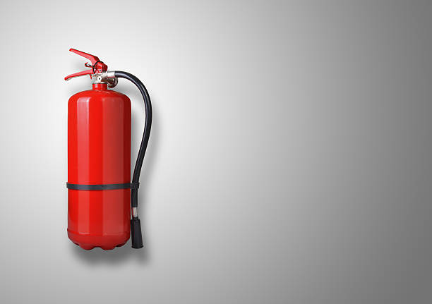 Fire extinguisher Fire extinguisher on the gray wall fire extinguisher photos stock pictures, royalty-free photos & images