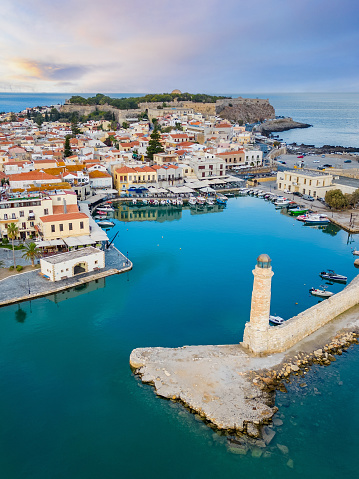 Old harbor and lighthouse of Rethymno in Crete, Greece. Famous landmark in the touristic destination.