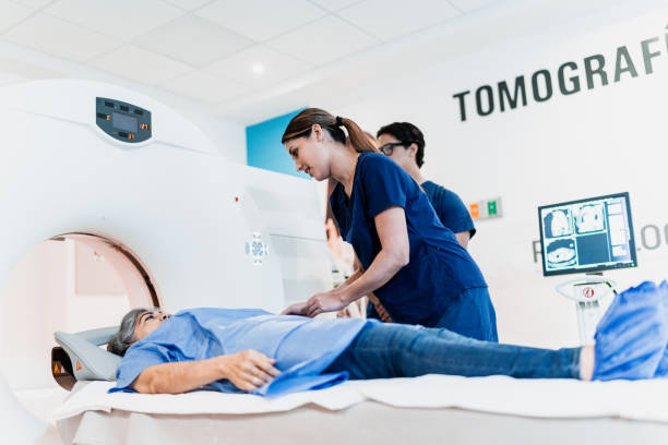 istock Female nurse talking while preparing patient for a tomography exam at hospital 1865037454
