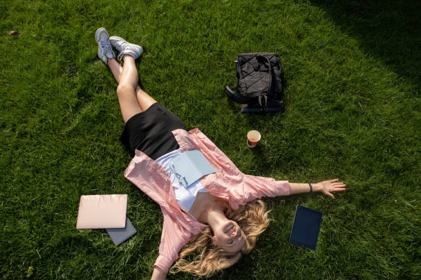 istock Young college student lies on grass resting after exams 1865038676