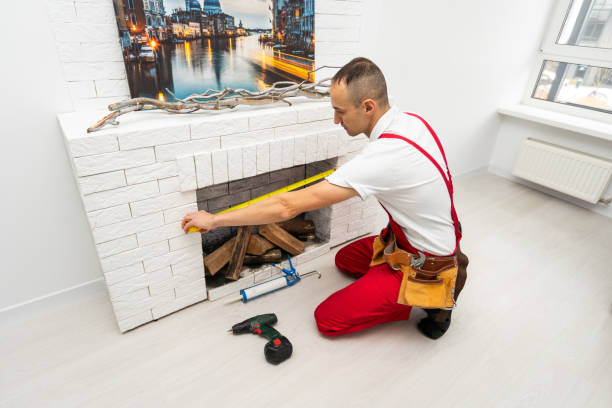istock Service technician repairing a fireplace in a home 1865044429