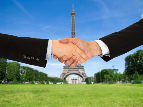 closing a deal with a handshake on a trip to Paris