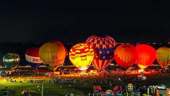 Bird in Hand, Pennsylvania, September 15, 2023 - An Aerial View of Hot Air Balloons Doing a Balloon Glow at Night on a Summer Evening
