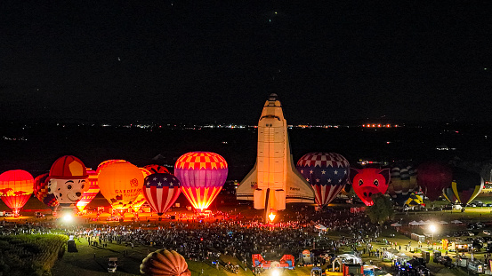Bird in Hand, Pennsylvania, September 15, 2023 - An Aerial View of Hot Air Balloons Doing a Balloon Glow With a Space Shuttle at Night on a Summer Evening