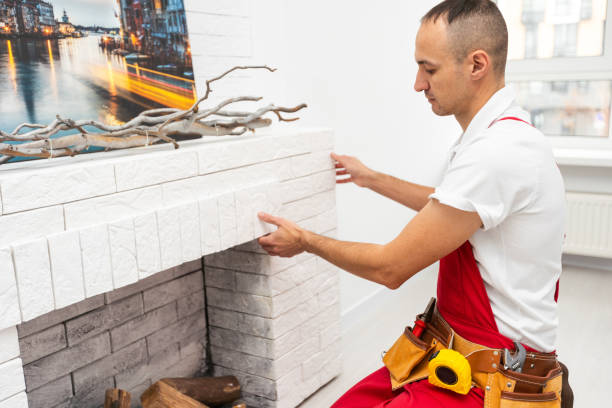 istock Professional technician installing electric fireplace in room 1865069073