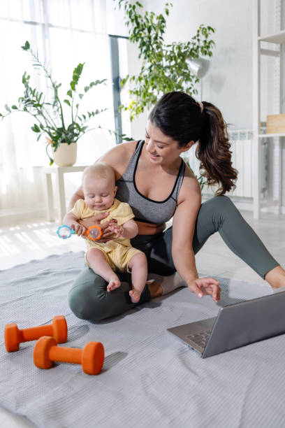 istock A young woman is practicing weight training with a video lesson on the laptop 1865073825
