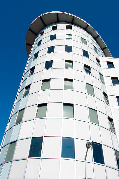 istock Oval building - blue sky and bright cylinder house with lamp 186507897