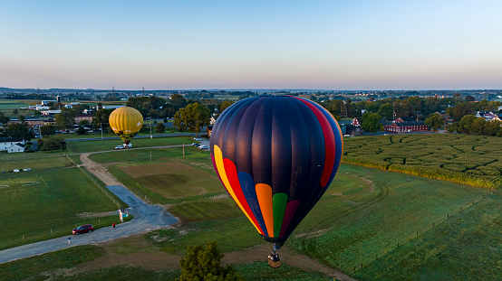 An Aerial View on Two Hot Air Balloons Launching, in the Early Morning, From a Field in Rural America, on a Sunny Summer Day