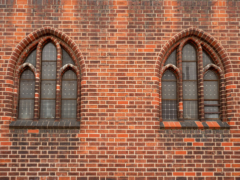 Windows of an old brick building. Ancient windows close-up.