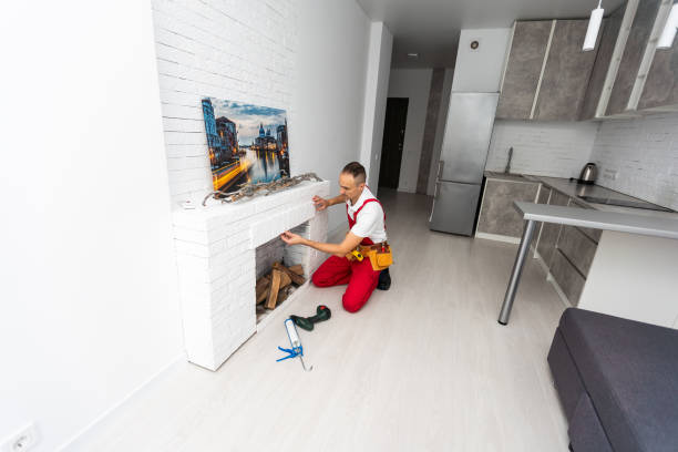 istock Professional technician installing electric fireplace in room 1865099967