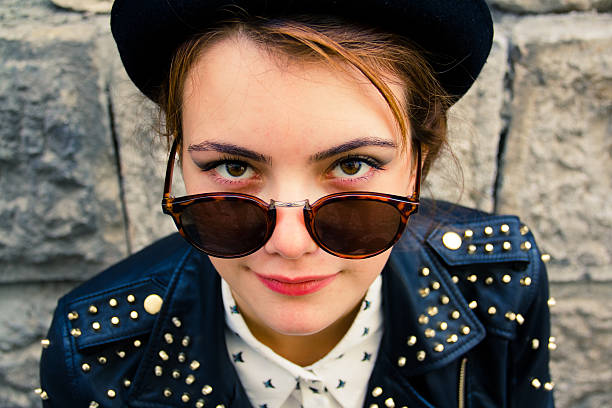 istock beautiful woman in front of brick wall 186510037