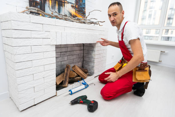 istock Professional technician installing electric fireplace in room 1865103652