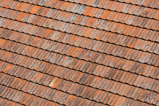 Detail of curved and textured, terracotta roof tiles used in home construction throughout Spain, Italy and Portugal and other southern European regions.