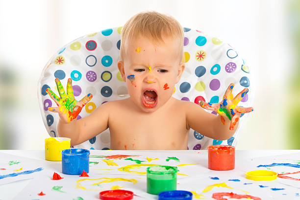 istock happy child draws with colored paints hands 186510860