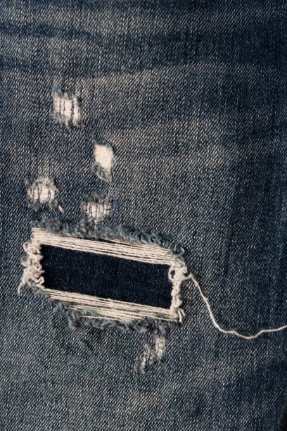 istock Torn and frayed denim pant leg 1865109138