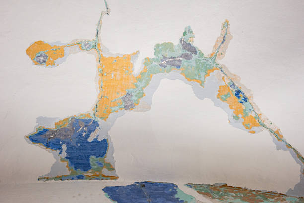 istock Abstract, detail, pattern of multi-colored peeling paint layers behind a white surface on an old stone interior wall of a building in Jerusalem, Israel. 1865112342