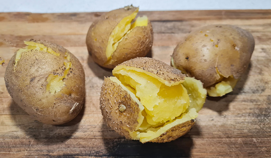 Fresh potatoes in sack on wooden