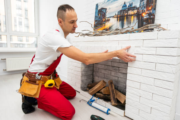 istock Professional technician installing electric fireplace in room 1865117674