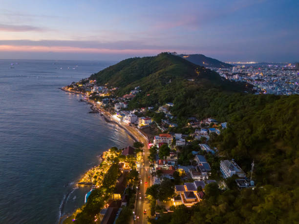 istock Panoramic coastal Vung Tau view from above, with waves, coastline, streets, coconut trees, Mount Nho in Vietnam behind the statue of Christ the King 1865124173