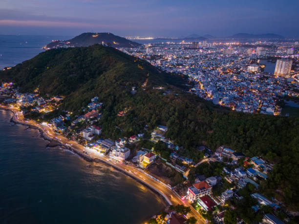 istock Panoramic coastal Vung Tau view from above, with waves, coastline, streets, coconut trees, Mount Nho in Vietnam behind the statue of Christ the King 1865125782