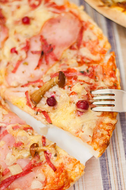 istock Appetizing pizza with mushrooms and ham 186514470