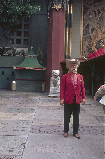 Los Angeles, California, USA, 1968. Tourist guide in front of the TCL Chinese theater on Hollywood Boulevard.