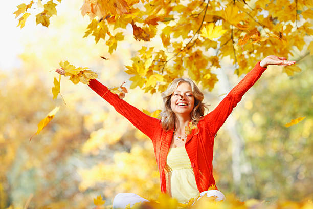 istock Happy woman in autumn park 186518044