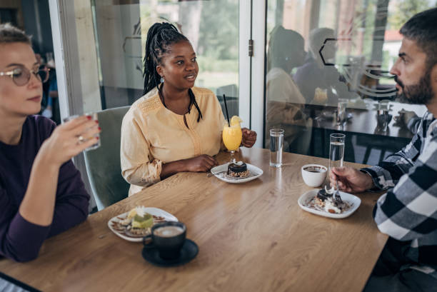 istock Friends sitting outdoors in restaurant 1865183615