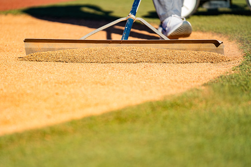 Baseball groundskeeping raking field dirt