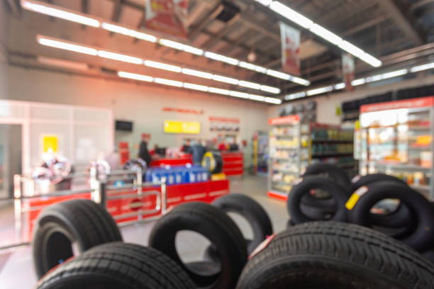 Blurred image rows of brand new tires for sale at retail store. Blurred image rows of brand new tires for sale at retail store. Defocused background interior of auto and tire trading store. Transportation services concept. Vintage tone. auto parts warehouse stock pictures, royalty-free photos & images