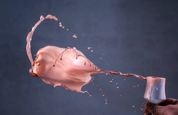 istock Craftsman throwing paint splash onto wall to create abstract art 1865208746