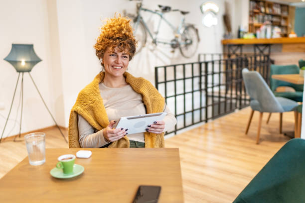 istock Woman using tablet at coffee shop 1865208945