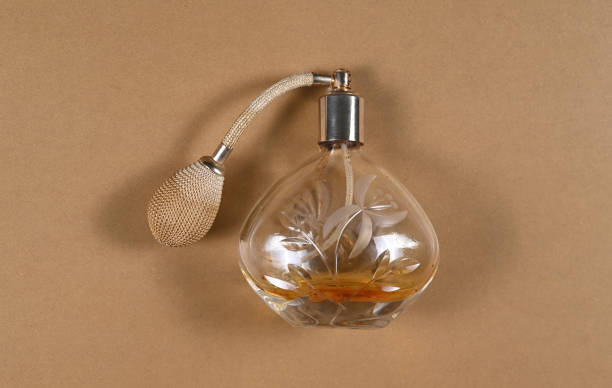 istock Vintage bottle of perfume with atomizer on gold banner template 1865208953