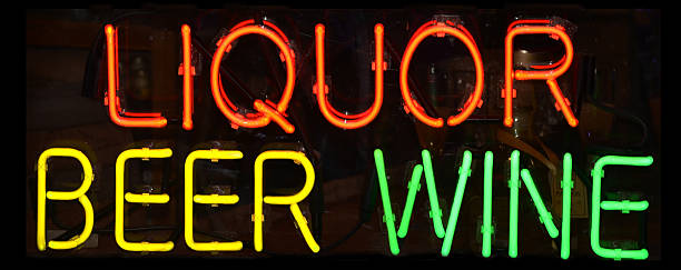 Neon lights spelling out liquor beer wine stock photo