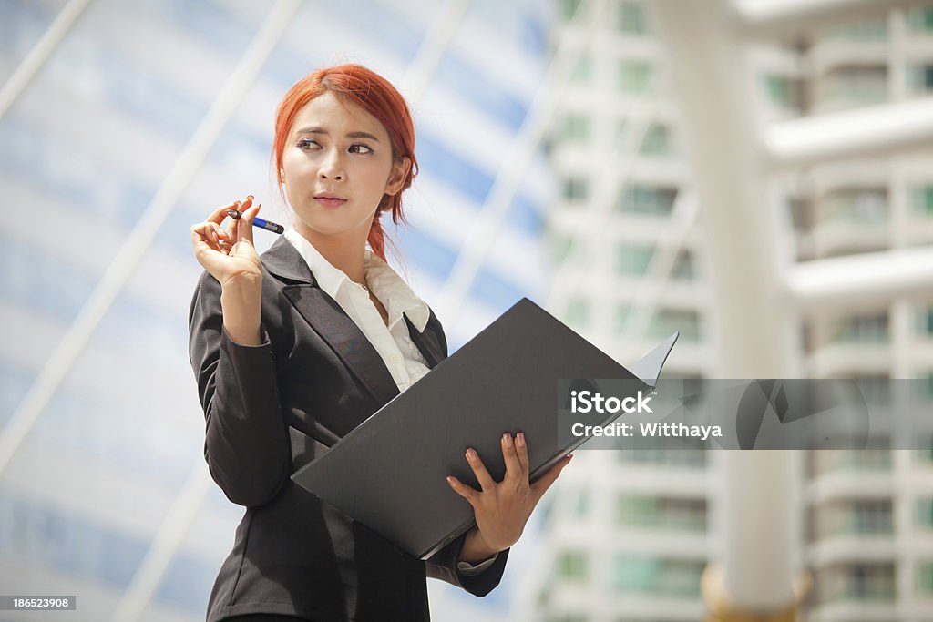 business woman with document Young business asian woman with document at modern city Adult Stock Photo
