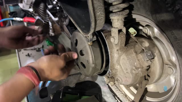 Close-up of mechanic repairing motorcycle.