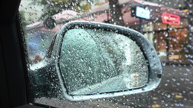 Water drops on the driver's side of the car. Side-view mirror