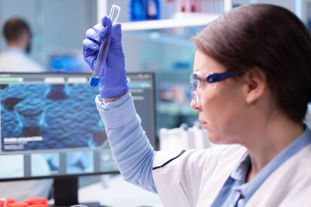 istock Scientist looking into test tube for biochemistry test 1865305229