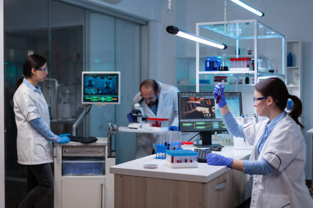 istock Professional doctor scientist looking in computer analysing DNA image scan 1865312512