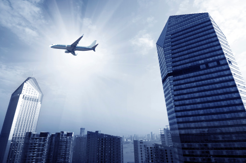 Shanghai's skyscrapers and airplanes on sky