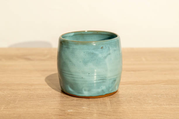 istock Big handmade ceramic blue mug on a wooden table 1865325746