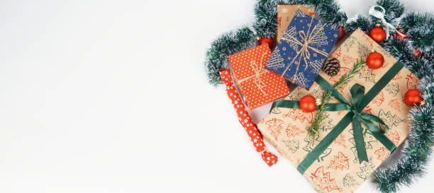 istock Banner with gift boxes tied ribbons and paper decorations on white background. 1865338861