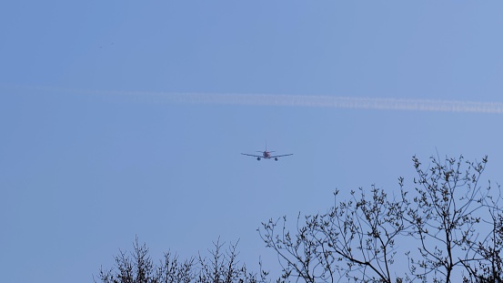 Airliner with passengers on the blue sky. The plane flies in the sky. The plane takes off against a clear sky.