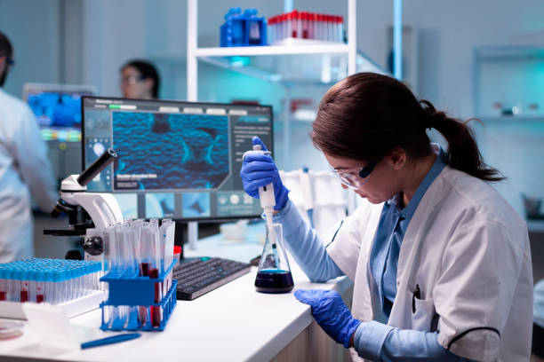 istock Chemistry doctor in engineering virus with mciropiette 1865351489