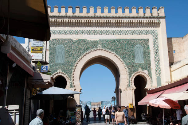 Bab Boujeloud gate in Fez Fes, Morocco - may 16, 2023: view of the Bab Boujeloud gate, the main entrance to the ancient souk of the medina in Fes in Morocco. bab boujeloud stock pictures, royalty-free photos & images