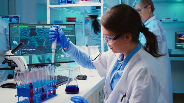 istock Chemist putting liquid in test tube with micropipette 1865357789