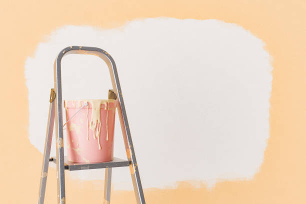 istock 3D Rendering of Paint Bucket on Ladder Against Half-Painted Wall 1865360972